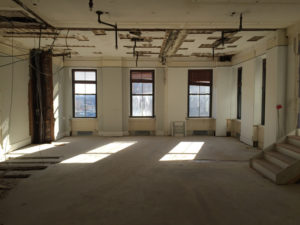 GUTTED: Originally a grocery store, 32 Custom House headquartered a variety of offices prior to being purchased by HM Ventures Group 7 in 2014. / COURTESY ASH NYC