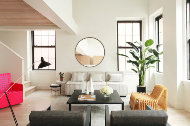 MODERN LOOK: The open-concept living spaces were designed to couple the building's original features with a clean, modern design. Large windows with updated casings overlook downtown Providence and the neighboring canal. / COURTESY ASH NYC