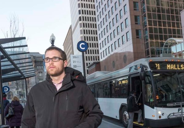 ON THE GO: James Kennedy, a transportation blog editor, in Kennedy Plaza near the RIPTA bus stops. Kennedy uses a bike, rides the bus and occasionally drives. / PBN PHOTO/MICHAEL SALERNO
