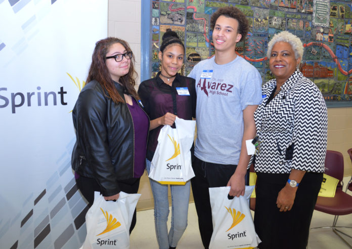 FROM LEFT to right, Alvarez High School students Danielle Garcia, Charmin Aquino, Matthew Silvia and Principal Zawadi Hawkins take a moment to celebrate after the students received free wireless connections and mobile devices on Jan. 27 as part of the Sprint 1Million project. / COURTESY PROVIDENCE PUBLIC SCHOOLS