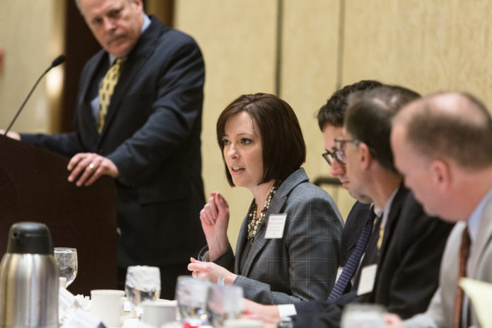 MONICA NERONHA, vice president and deputy general counsel for Blue Cross & Blue Shield of Rhode Island, makes a point during Providence Business News' Health Care Reform Summit 2017, held Thursday at the Crowne Plaza Providence Warwick. PBN Editor Mark S. Murphy, left, moderated the panel, while other panelists included, from Neronha's left, Zachary Sherman, executive director of HealthSource RI, Dr. Peter Hollmann, chief medical officer of University Medicine Foundation and Peter Marino, president and CEO of Neighborhood Health Plan of Rhode Island. / PBN PHOTO/RUPERT WHITELEY