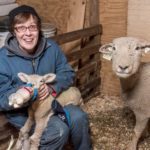 STEADY GROWTH: Debra Hopkins, owner of Hopkins Southdowns farm in North Scituate, feeds a lamb. The family-run sheep farm has been run by the Hopkins family for 40 years. They sell meats, primarily, but also wool products. / PBN PHOTO/MICHAEL SALERNO