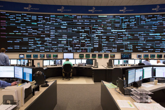 ELECTRIC EYE: A series of numbers and symbols on a board depict a real-time simulation of the region's power grid. The board tells ISO New England how much electricity is needed versus how much is being produced across New England. The independent nonprofit, based in Holyoke, Mass., oversees day-to-day operations of the region's bulk power system. / COURTESY ISO NEW ENGLAND