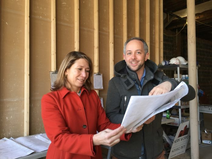 SARA HIEBNER, vice president of commercial lending at Centreville Bank, reviews plans with Chis Bender for expanding his restaurant business in Newport. / COURTESY CENTREVILLE BANK
