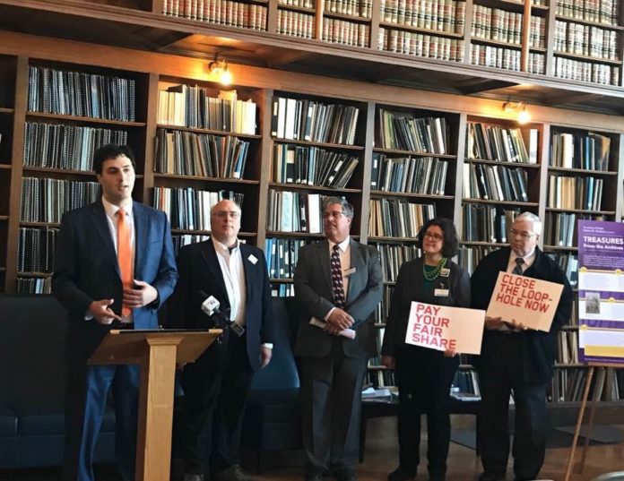 REP. AARON REGUNBERG, left, D-Providence, stands with supporters announcing a bill to tax carried interest income like earned income. / COURTESY AARON REGUNBERG