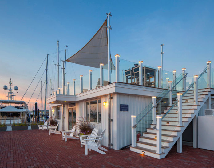 MODERN UPDATE: Peregrine Group LLC brought the Newport Yachting Center's marina office to modern times by completely stripping and re-creating the building. The doors to the office have been moved to face the harbor, and a staircase in place of the original entry now leads marina guests to a new rooftop deck. / COURTESY PEREGRINE GROUP LLC