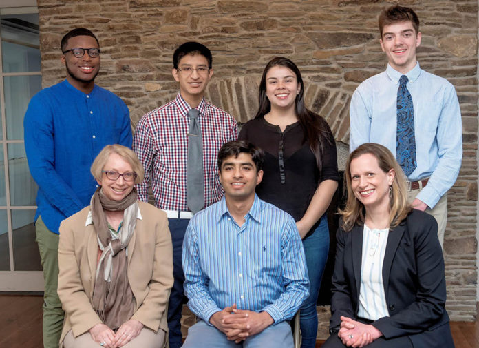UNIVERSITY OF Rhode Island engineering students, back row, from left, Corvah Akoiwala, Cristian Witcher, Laura Parra and James Gannon, will travel to Colombia this summer with prosthetic arms and hands they have made for amputees. The project is funded by a federal grant from the “100,000 Strong in the Americas” program. In the front row are, from left, Sigrid Berka, director of the International Engineering Program at URI; Kunal Mankodiya, assistant professor of biomedical engineering at URI; and Silke Scholz, director of the Spanish International Engineering Program at URI. / COURTESY UNIVERSITY OF RHODE ISLAND/MICHAEL SALERNO
