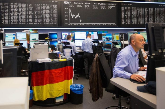 INVESTORS ARE CONSIDERING moving out of U.S. equities to European stocks, based on the assumption that the recent run-up in the United States overvalues American stocks, while Europeans stocks are seen as being under-valued. Traders at the Frankfurt Stock Exchange in Germany monitor data in this photo. / BLOOMBERG NEWS PHOTO/KRISZTIAN BOCSI