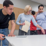 TEACHABLE MOMENTS: Brickle Group employees Roddy Rodriguez, left, and Belanie Medina, right, take part in a Manufacturing Center of Excellence class being taught at the New England Institute of Technology by mechanical-engineering instructor Annie Unger. / PBN PHOTO/MICHAEL SALERNO