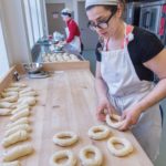 Milena Pagan, owner of Rebelle Artisan Bagels, at Hope & Main in Warren working on producing product for customers. In the background is Rebecca Atwood, baker. PBN PHOTO/MICHAEL SALERNO
