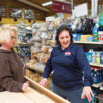 LOYAL CUSTOMER: Donna Brodeur, left, owner of the Olde Primitive Crow and a regular customer of Pepin Lumber, talks with Jeanne Pepin Budnick, Pepin Lumber co-owner. / PBN PHOTO/TRACY JENKINS