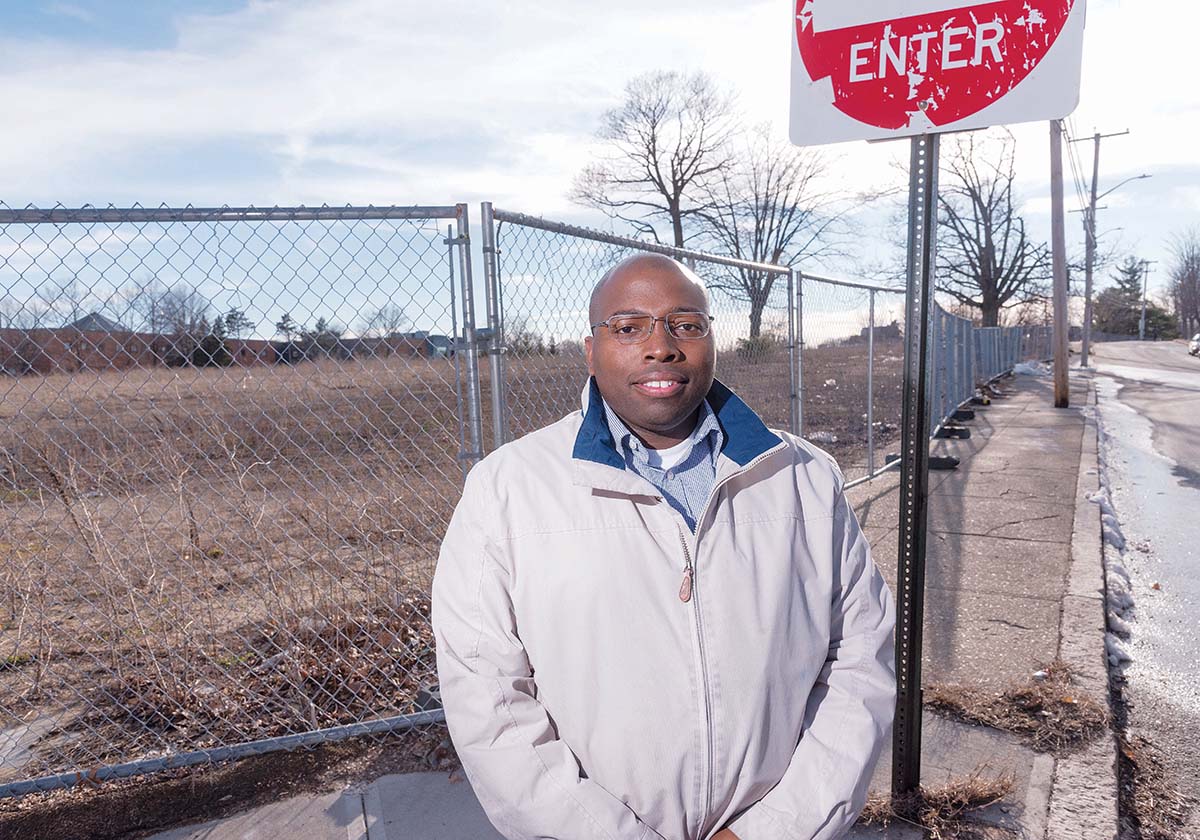 CLEARED TO BUILD: Dwayne Keys, chairman of the South Providence Neighborhood Association, stands outside the former Flynn Elementary School on Blackstone Street, where a developer has proposed a $30 million to $40 million mixed-use project. / PBN PHOTO/MICHAEL SALERNO