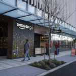 A PEDESTRIAN PASSES in front of the new Amazon Go grocery store in Seattle. The retail giant unveiled technology that will let shoppers grab groceries without having to scan and pay for them - in one stroke eliminating the checkout line.