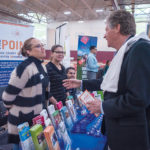 LISTENING: Endeavoring to promote the state’s small-business community, Lt. Gov. Daniel McKee, right, hosted a discussion at the 6th Annual Latino Business Expo. Here, McKee talks with, from left, Maria Sol Cuesta and Marleny Perez, bilingual benefit specialists at The Point. / PBN PHOTO/­MICHAEL SALERNO