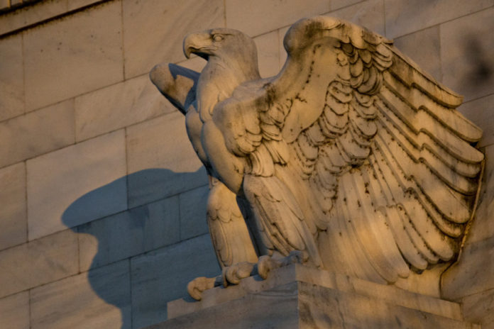 AN EAGLE sculpture stands on the facade of the Marriner S. Eccles Federal Reserve building in Washington, D.C./ BLOOMBERG NEWS PHOTO/ ANDREW HARRER