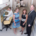 NEW INCUBATOR: BioSci Labs is a newly created, combined workspace and incubator in Coventry. From left, standing, Elizabeth A. Stone, director of BioSci Labs; Krista A. Jarrell, investor; John D. Jarrell, president of Materials Science Associates and Biointerface Inc. Seated and working, front to rear, Jay Vincelli, director of Materials Characterization and Failure Analysis Lab; Michael A. Stone, director of Marine Research; Crystal M. Vogel, research assistant from Veterans Assembled Electronics. / PBN PHOTO/MICHAEL SALERNO
