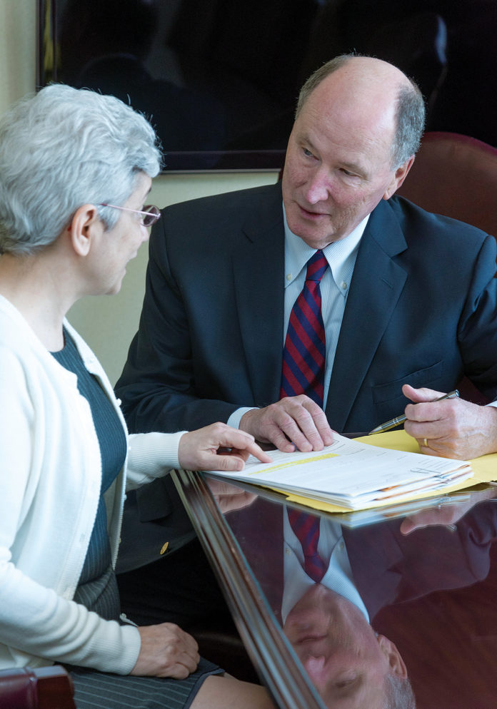 HELPING HANDS: Keith Lang, executive director of 84-year-old, Cranston-based Champlin Foundation, speaks with Donna Maria Blanchette.  / PBN PHOTO/MICHAEL SALERNO
