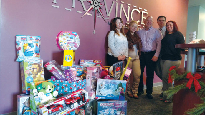 A POSITIVE REFLECTION: Province Mortgage Associates staff took part in a Toys for Tots campaign during the 2016 holiday season. / COURTESY PROVINCE MORTGAGE ASSOCIATES