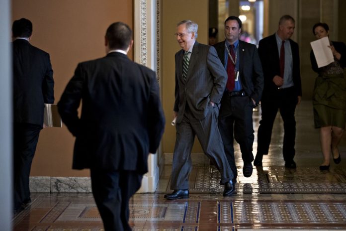 SENATE MAJORITY LEADER MITCH McConnell, a Republican from Kentucky, center, walks to a private GOP meeting at the U.S. Capitol. /BLOOMBERG FILE PHOTO/ANDREW HARRER SENATE MAJORITY LEADER MITCH McConnell, a Republican from Kentucky, center, walks to a private GOP meeting at the U.S. Capitol. /BLOOMBERG FILE PHOTO/ANDREW HARRER
