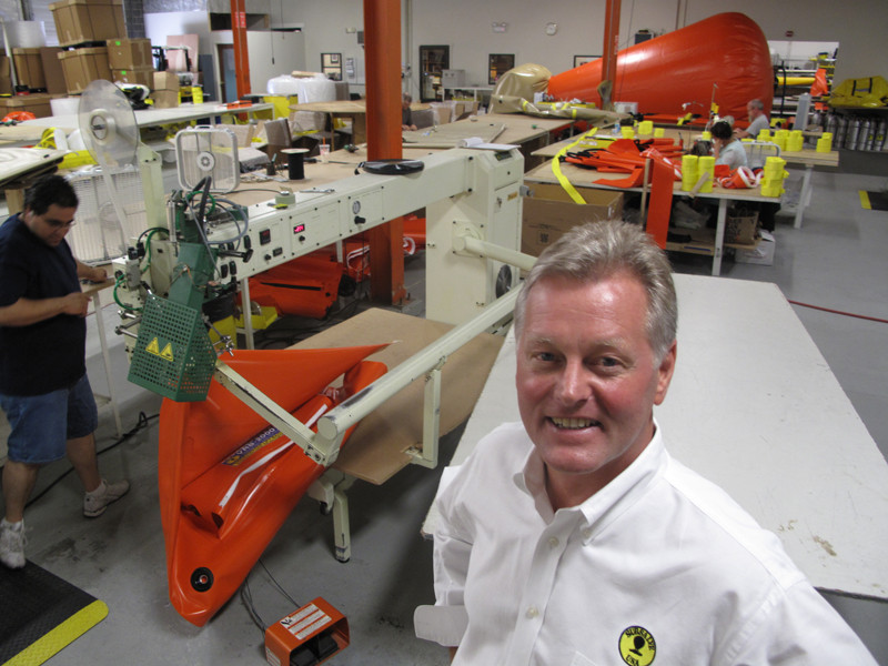 SUBSALVE USA'S CHIEF Growth Officer Richard G. Fryburg in the company's North Kingstown facility, where workers are assembling flotation devices for undersea salvage operations. The bag being tested in the back can lift 77,000 lbs. PBN FILE PHOTO/MARK S. MURPHY