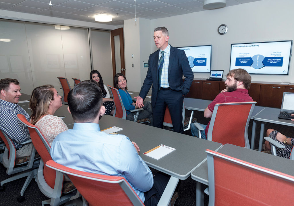 PROACTIVE APPROACH: Tim Hebert, chief client officer for Carousel Industries of North America Inc., in Exeter, gives an in-house job-training program that’s produced dozens of employees for his company, Atrion, which was ­acquired by Carousel Industries last year. / PBN PHOTO/MICHAEL SALERNO