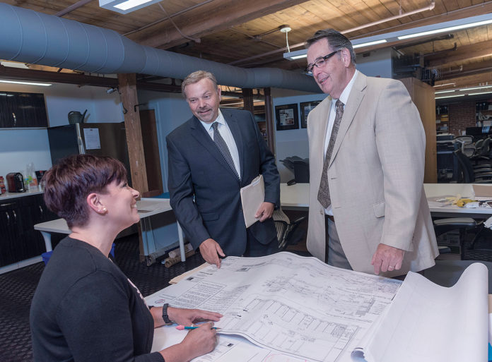 MAKING CONNECTIONS: David DeQuattro, center, managing principal of RGB Architects in Providence, as well as a U.S. Air Force and Air National Guard veteran, believes veterans make for high-quality workers. Gina Anderson, job captain for RGB, and Richard Jackson, project manager, also served in the Air Force. / PBN PHOTO/MICHAEL SALERNO MAKING CONNECTIONS: David DeQuattro, center, managing principal of RGB Architects in Providence, as well as a U.S. Air Force and Air National Guard veteran, believes veterans make for high-quality workers. Gina Anderson, job captain for RGB, and Richard Jackson, project manager, also served in the Air Force. / PBN PHOTO/MICHAEL SALERNO