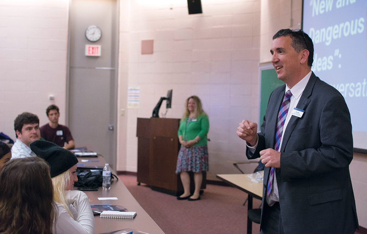 LOCAL HISTORY: Robert Shea, right, associate provost for the advancement of teaching and learning at Roger Williams University, speaks to students during Roger Seminar, which introduces first-year students to Roger Williams as a historical figure by studying texts by ­Williams and those analyzing his role in local history. / COURTESY ROGER WILLIAMS UNIVERSITY