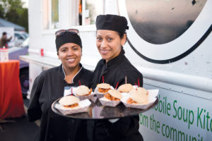 STREET EATS: Food-truck vendors serve up sandwiches during the Truck Stop: A Festival of Street Eats, an annual event sponsored by Stop & Shop and held in April in the Rhode Island Community Food Bank parking lot. / COURTESY RHODE ISLAND COMMUNITY FOOD BANK