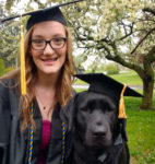 URI students graduate alongside dog trainers UNIVERSITY OF RHODE ISLAND senior Caitlyn Landry and Navy, a black lab she has trained for a year to become a guide dog, prepare for graduation. /COURTESY UNIVERSITY OF RHODE ISLAND/NORA LEWIS