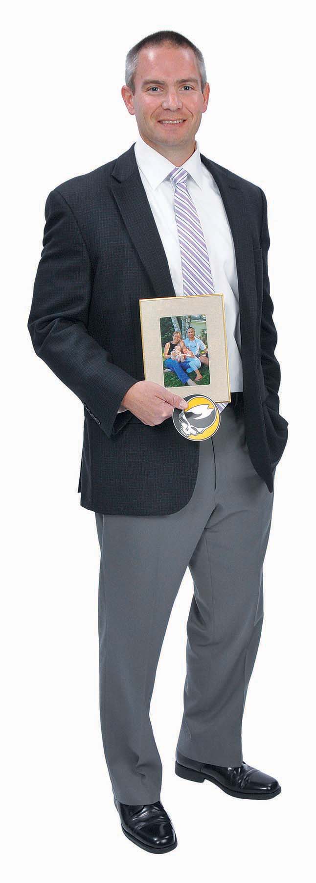 THE PROP: Jeffrey P. Spratt, dedicated at work and at home, holds his company’s logo and a family photo with his wife, Sharon, and daughters, Abby, 4, and Ellie, 1. THE PROP: Jeffrey P. Spratt, dedicated at work and at home, holds his company’s logo and a family photo with his wife, Sharon, and daughters, Abby, 4, and Ellie, 1.