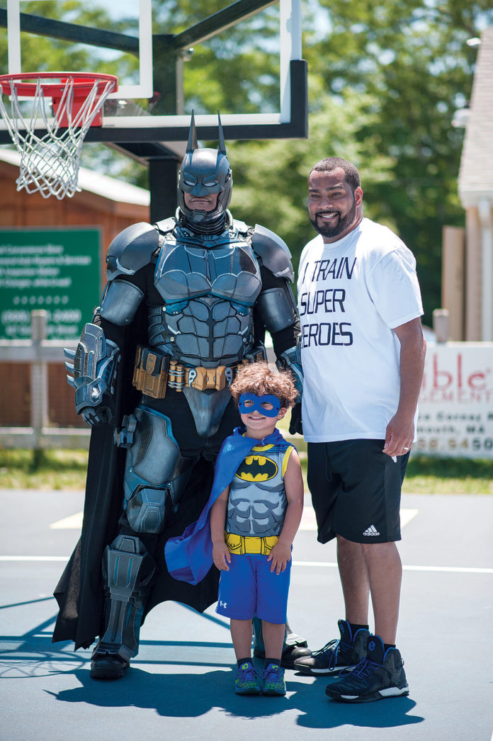 PEER HEROES: Manny DeBrito, right, formed A’s be4 to train mentors to work with local youth. He’s pictured with Raymond Ramos (Batman) and his 4-year-old son Theo DeBrito. / COURTESY JACKIE YOUNG/JACQUELYN CAROL CO.
