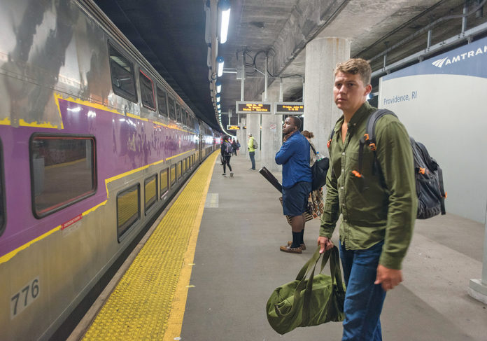 A passenger waits to board an MBTA commuter train in Providence. / PBN FILE PHOTO/­MICHAEL SALERNO / PBN FILE PHOTO/­MICHAEL SALERNO