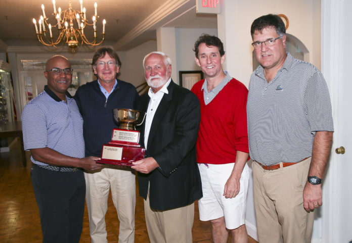 LAWRENCE A. AUBIN SR., center, co-chair of the Hasbro Children’s Hospital Invitational and chairman of the Lifespan board of directors, presents the Hasbro Cup. From left, Dr. G. Dean Roye; Dr. William Cioffi; Aubin; Dr. David Harrington; and Dr. Stephen Migliori. /COURTESY AL WEEMS PHOTOGRAPHY