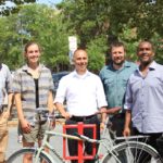 PROVIDENCE-BASED ARTS ORGANIZATION Steel Yard is donating 35 artist-designed bike racks in 16 cities and towns across the state. From left, Alex Ellis, Providence planning technician; Jenny Sparks, public projects client relations manager; Providence Mayor Jorge O. Elorza; Tim Ferland, public projects director; and Wobberson Torchon, principal of the Providence Career & Technical Academy. /COURTESY STEEL YARD