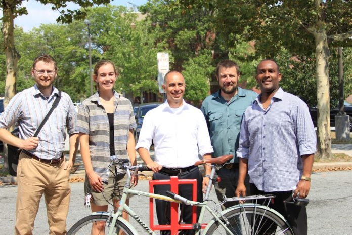 PROVIDENCE-BASED ARTS ORGANIZATION Steel Yard is donating 35 artist-designed bike racks in 16 cities and towns across the state. From left, Alex Ellis, Providence planning technician; Jenny Sparks, public projects client relations manager; Providence Mayor Jorge O. Elorza; Tim Ferland, public projects director; and Wobberson Torchon, principal of the Providence Career & Technical Academy. /COURTESY STEEL YARD