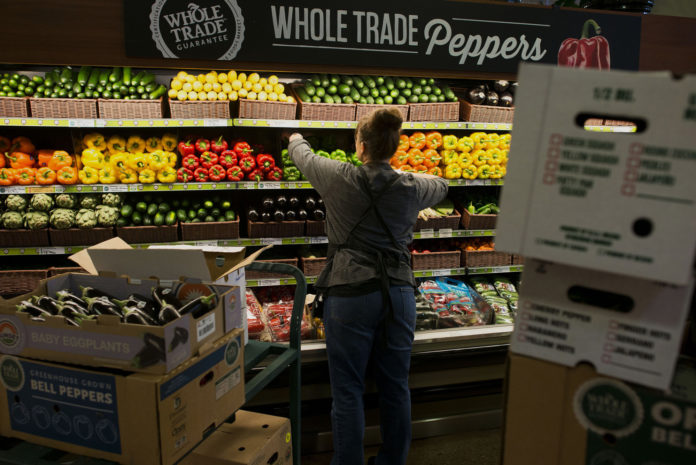 AMAZON WILL BEGIN slashing prices on a broad cross section of Whole Foods groceries Monday. / BLOOMBERG FILE PHOTO/TY WRIGHT