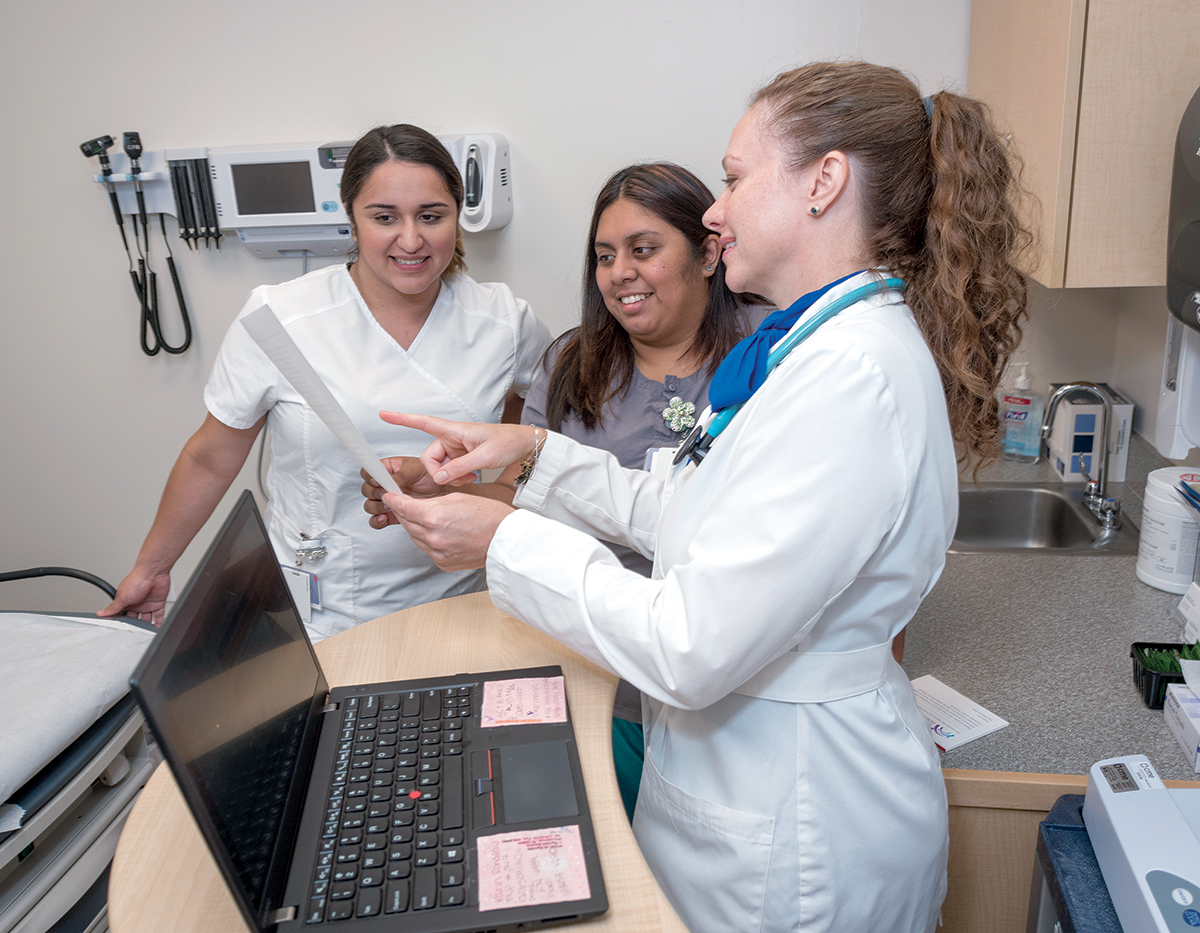 ASSISTING: Karin Rondeau, family nurse practitioner at the new Randall Square location of Providence Community Health Centers, talks with her medical assistants, Leslie Alvarez, left, and Celia Ortiz. / PBN PHOTO/MICHAEL SALERNO