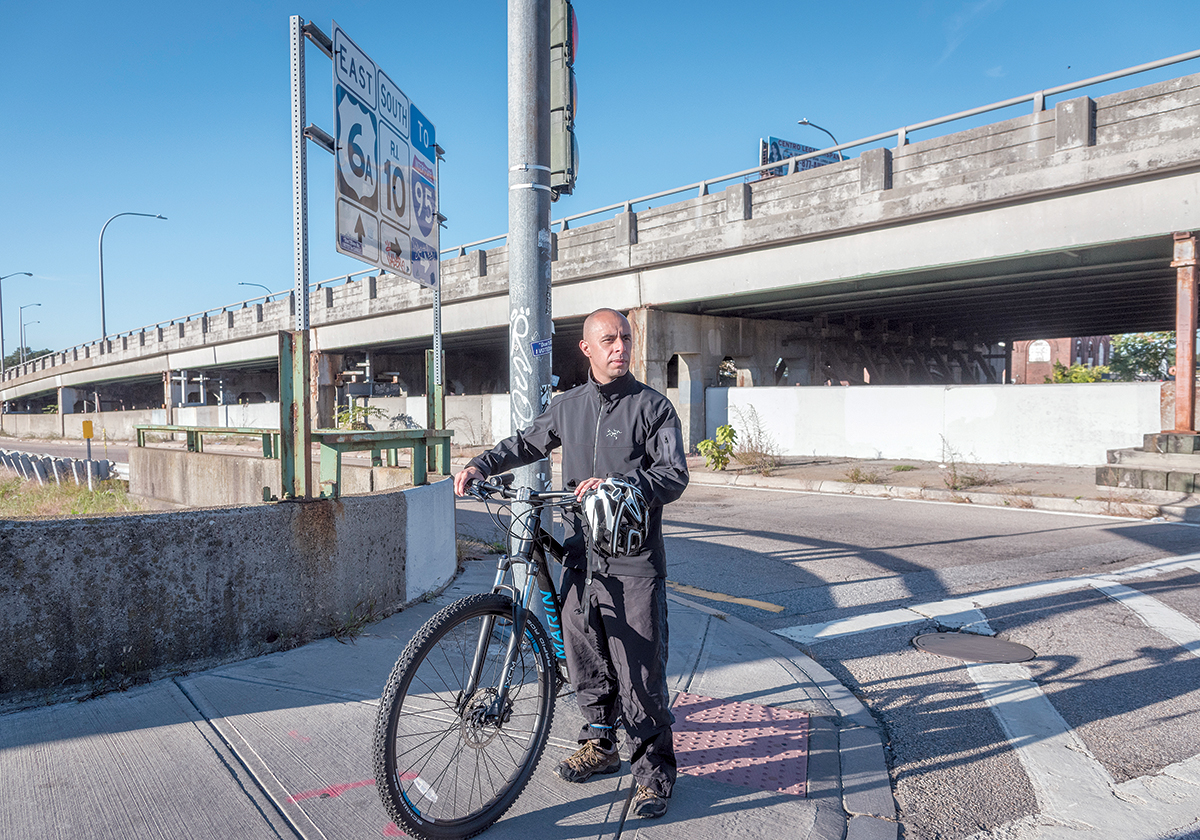 NEIGHBORHOOD ADVOCATE: Providence Mayor Jorge O. Elorza rides his bike by the 6-10 connector on Westminster Street in Providence most days. He says the roadway should connect neighborhoods, rather than divide them. / PBN FILE PHOTO/MICHAEL SALERNO