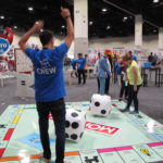 HasCon staff and attendees take turns throwing dice on a larger-than-life Monopoly board. PBN PHOTO/NICOLE DOTZENROD