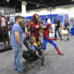 Guests pose with Iron Man and Spider-Man at HasCon. PBN PHOTO/NICOLE DOTZENROD