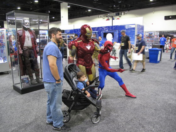 Guests pose with Iron Man and Spider-Man at HasCon. PBN PHOTO/NICOLE DOTZENROD