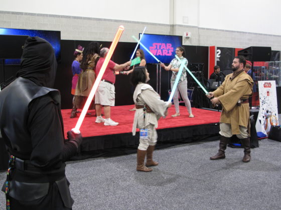 HasCon attendees try their hand at lightsaber duels. PBN PHOTO/NICOLE DOTZENROD