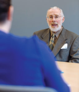 UPHILL BATTLE: Despite facing challenges such as a decline in international student population and international concerns that the United States is not as welcoming as it once was, Roger Williams University President Donald J. Farish says the school is working hard to diversify its population through measures such as providing full-ride scholarships to displaced Syrian students and hiring a chief diversity officer. / PBN PHOTO/RUPERT WHITELEY