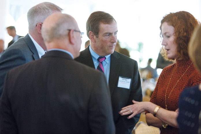 FOLLOW-UP: Sam Slade, center, vice president employer segment, Blue Cross & Blue Shield of Rhode Island, and Melissa Cummings, right, senior vice president, chief customer officer, BCBSRI, talk with attendees following the PBN Health Care Summit on Oct. 5. / PBN PHOTO/RUPERT WHITELEY