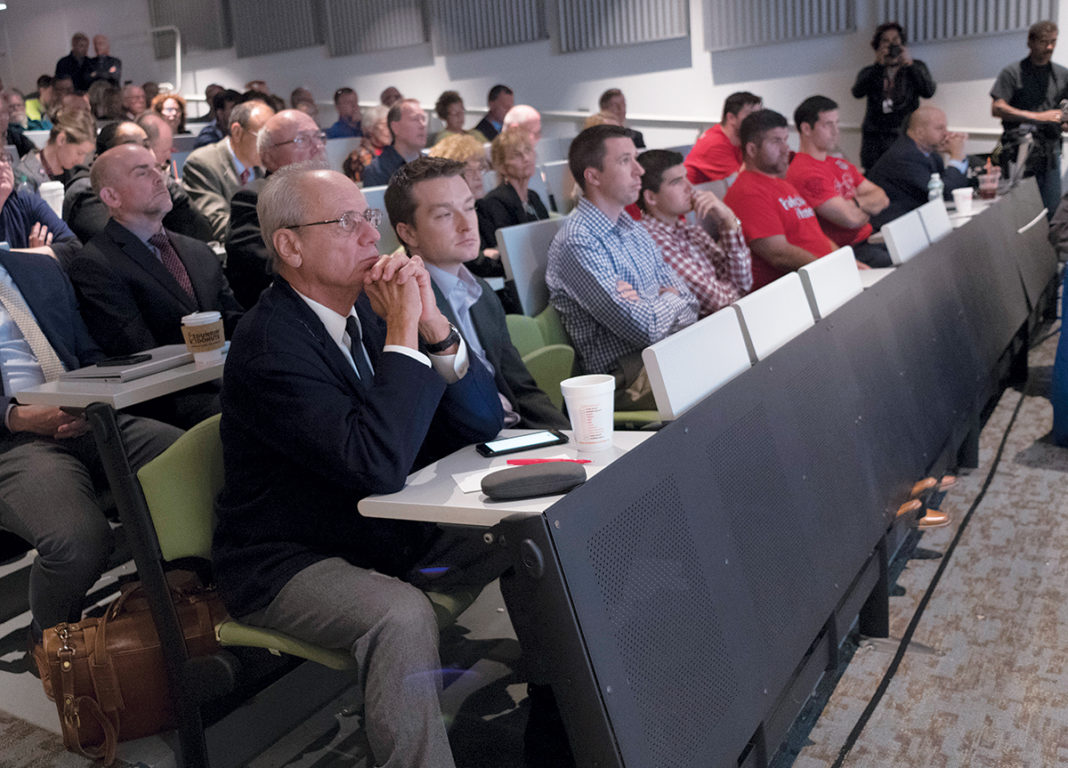 FRONT-ROW SEAT: Pawtucket Red Sox Chairman Larry Lucchino, at left in the front row, listens during a Senate Finance Committee hearing at the University of Rhode Island’s Swan Hall in South Kingstown, during which the team, the public and others provided feedback on the proposed PawSox stadium deal. / PBN PHOTO/MICHAEL SALERNO FRONT-ROW SEAT: Pawtucket Red Sox Chairman Larry Lucchino, at left in the front row, listens during a Senate Finance Committee hearing at the University of Rhode Island’s Swan Hall in South Kingstown, during which the team, the public and others provided feedback on the proposed PawSox stadium deal. / PBN PHOTO/MICHAEL SALERNO