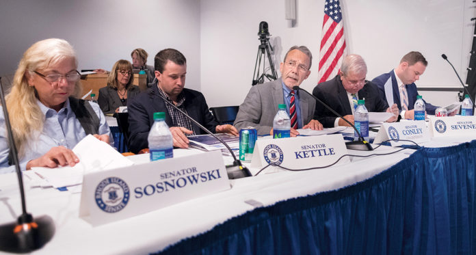 SEN. WILLIAM J. Conley Jr. (center), D-East Providence, is chairman of the Senate Finance Committee, center. He listens to testimony related to Pawtucket Red Sox legislation last year. / PBN FILE PHOTO/MICHAEL SALERNO