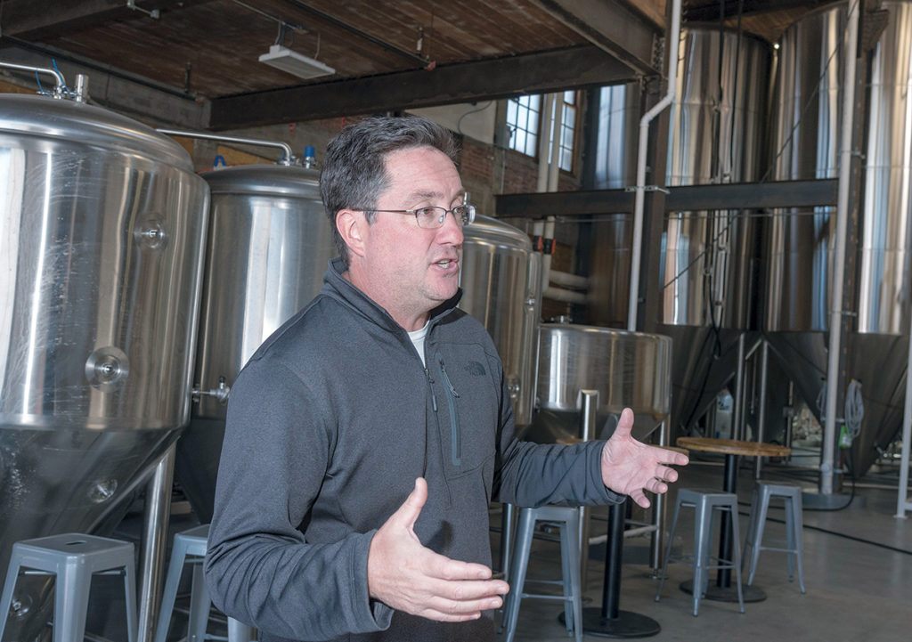 BUILDING BLOCK: Jeremy Duffy, co-founder of Isle Brewers Guild, says the co-op has become an anchor in its neighborhood near the downtown. / PBN PHOTO/MICHAEL SALERNO