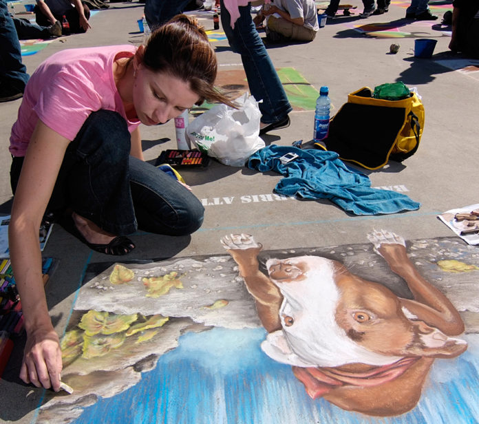 A LOCAL ARTIST displays her work at a recent Providence Rotary Club Street Painting Festival. / COURTESY PROVIDENCE ROTARY CLUB