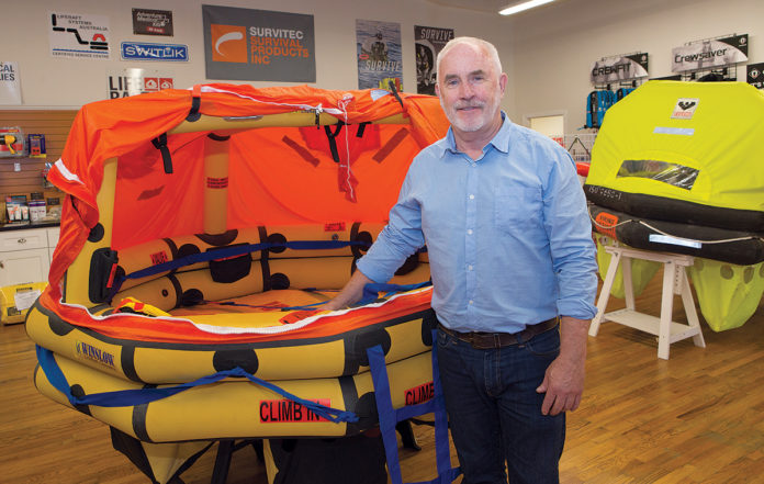 ONE-STOP SHOP: Jim O’Connor is the owner of Life Raft & Survival Equipment Inc. in Tiverton. The company not only sells protective gear to mariners but also maintains and inspects it, which is required yearly for commercial vessels. / PBN PHOTO/KATE WHITENEY LUCEY ONE-STOP SHOP: Jim O’Connor is the owner of Life Raft & Survival Equipment Inc. in Tiverton. The company not only sells protective gear to mariners but also maintains and inspects it, which is required yearly for commercial vessels. / PBN PHOTO/KATE WHITENEY LUCEY