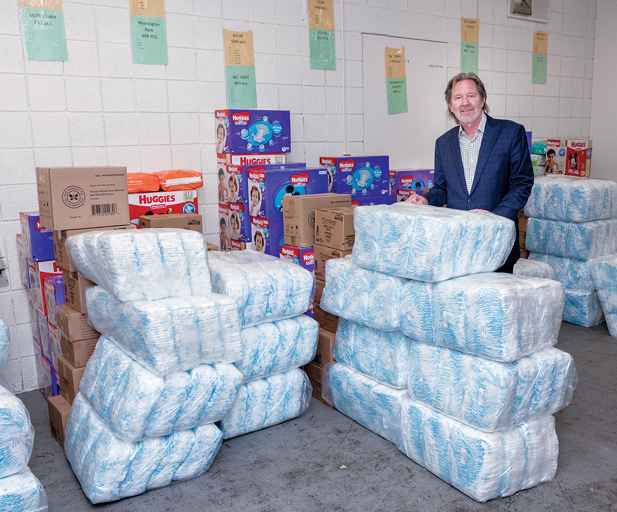 UNDERCOVER INVENTORY: Richard Fleischer, president of Project Undercover, which supplies diapers, underwear, socks and wipes to families in need, stands among the nonprofit’s inventory at its Providence warehouse.  / PBN PHOTO/MICHAEL SALERNO